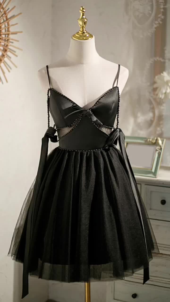 This contains: Unique Black Cutout Short Homecoming Dress with Straps