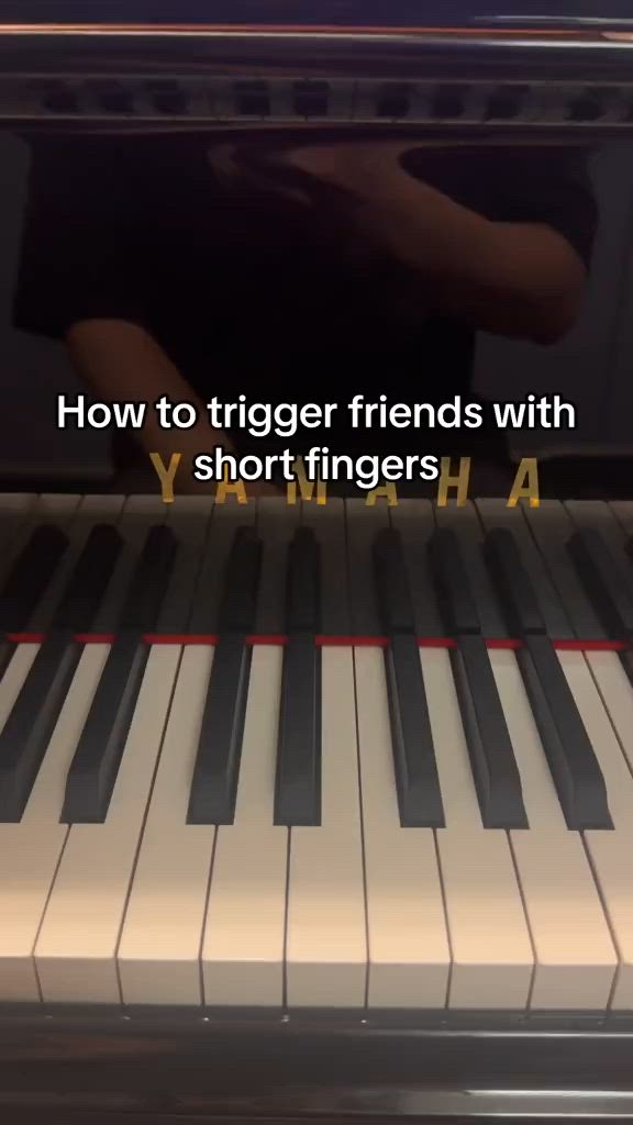 This may contain: someone is playing the piano with their hand and fingers in front of an electronic keyboard