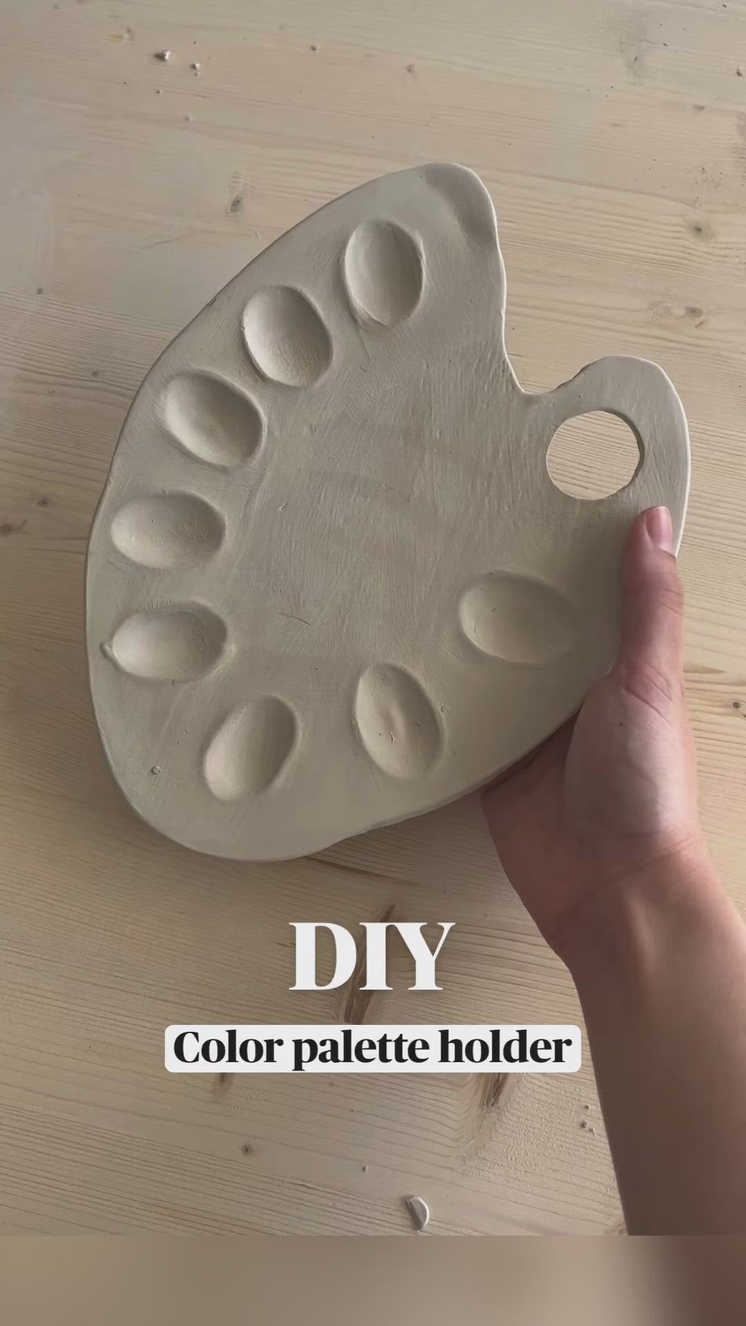 This may contain: a hand holding a white tray with holes in it and the words diy color palette holder