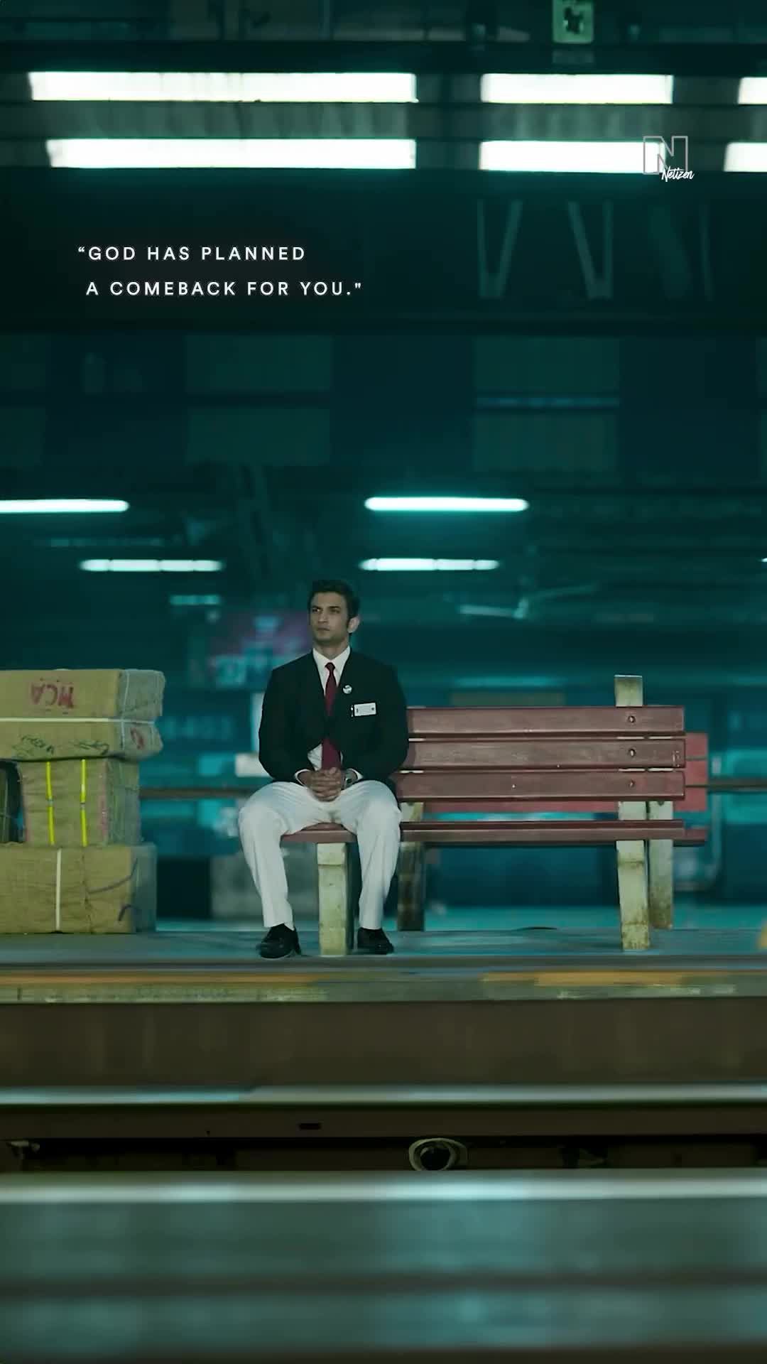 This may contain: a man sitting on top of a wooden bench next to a pile of boxes in a train station