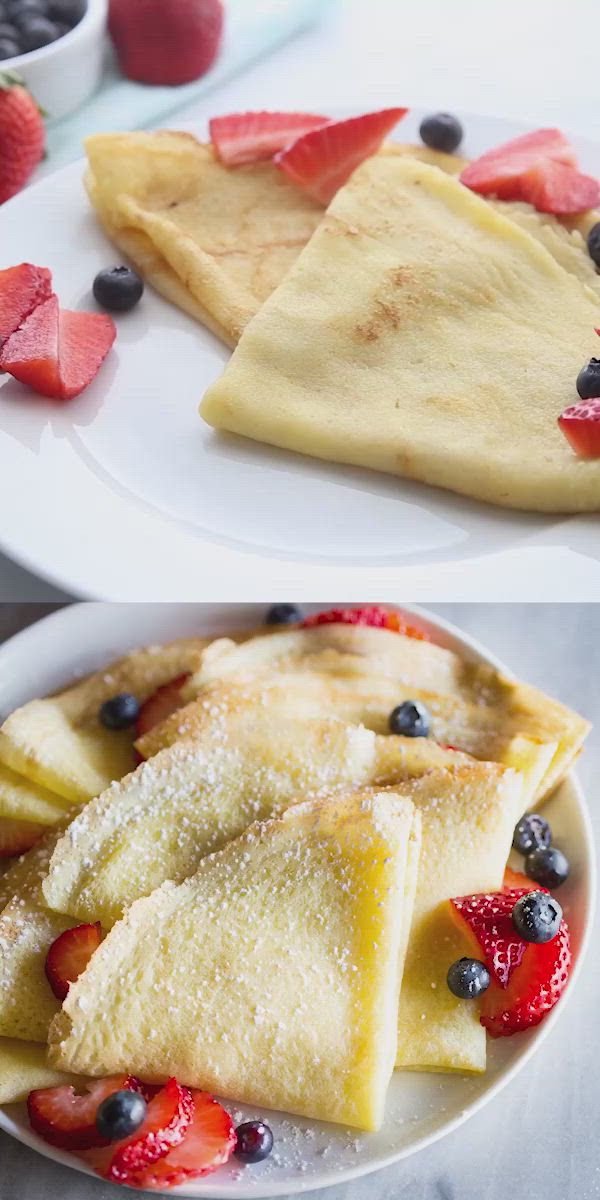 This may contain: two plates with crepes, strawberries and blueberries on them next to each other