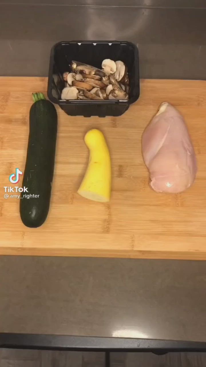 This may contain: the ingredients for this dish are displayed on a cutting board, along with an eggplant, mushrooms, and zucchini