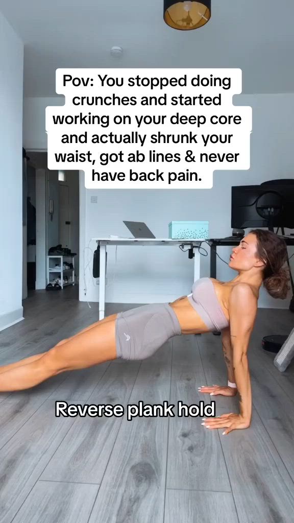 This may contain: a woman is doing push ups on the floor in front of a computer desk and chair