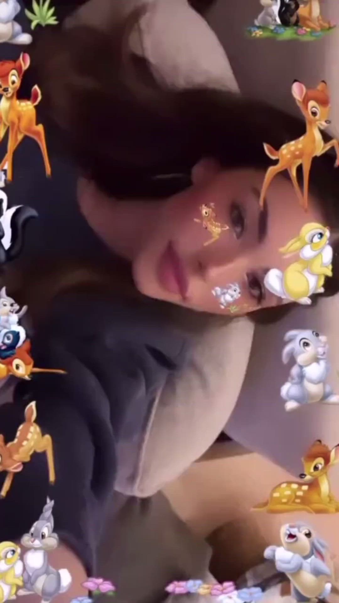 This may contain: a woman laying in bed with many stickers on her face