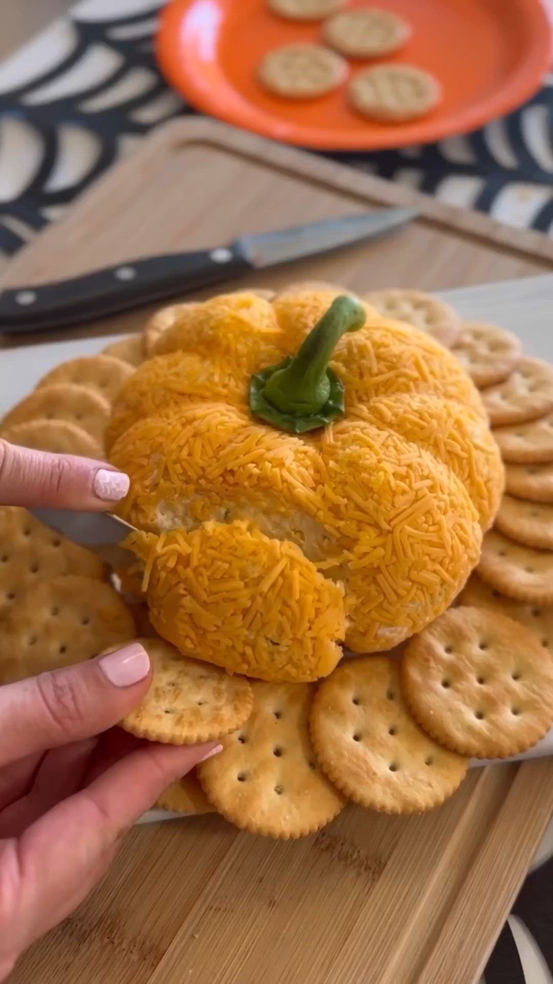 This may contain: a pumpkin made out of crackers on a plate