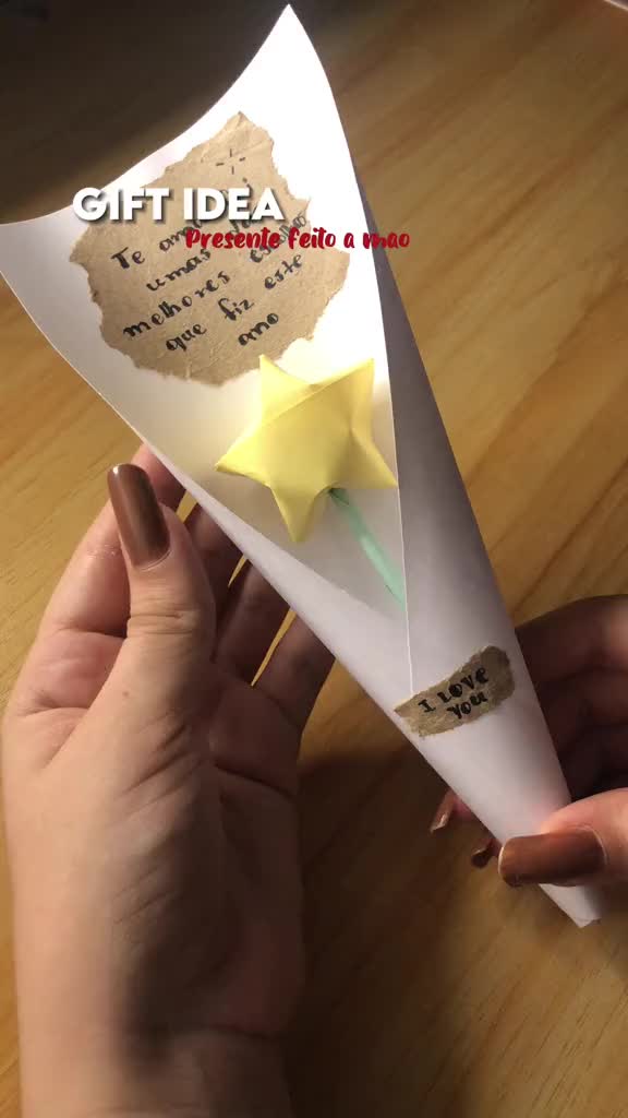 This may contain: a person is holding a paper cone with writing on it that says, gift idea