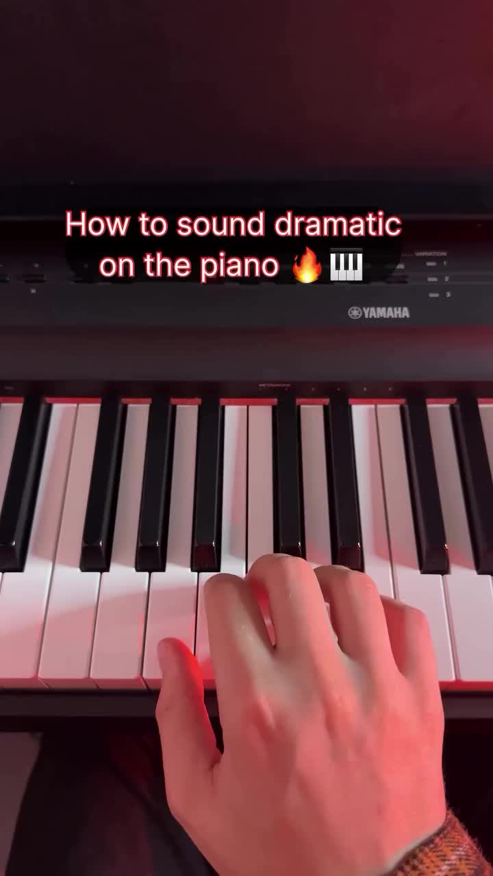 This may contain: someone is playing the piano with their hand on it and an abc e sign above them