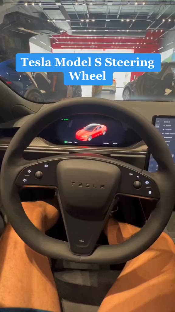 This may contain: the tesla model s steering wheel on display at an auto show with text overlay that reads tesla model s steering wheel