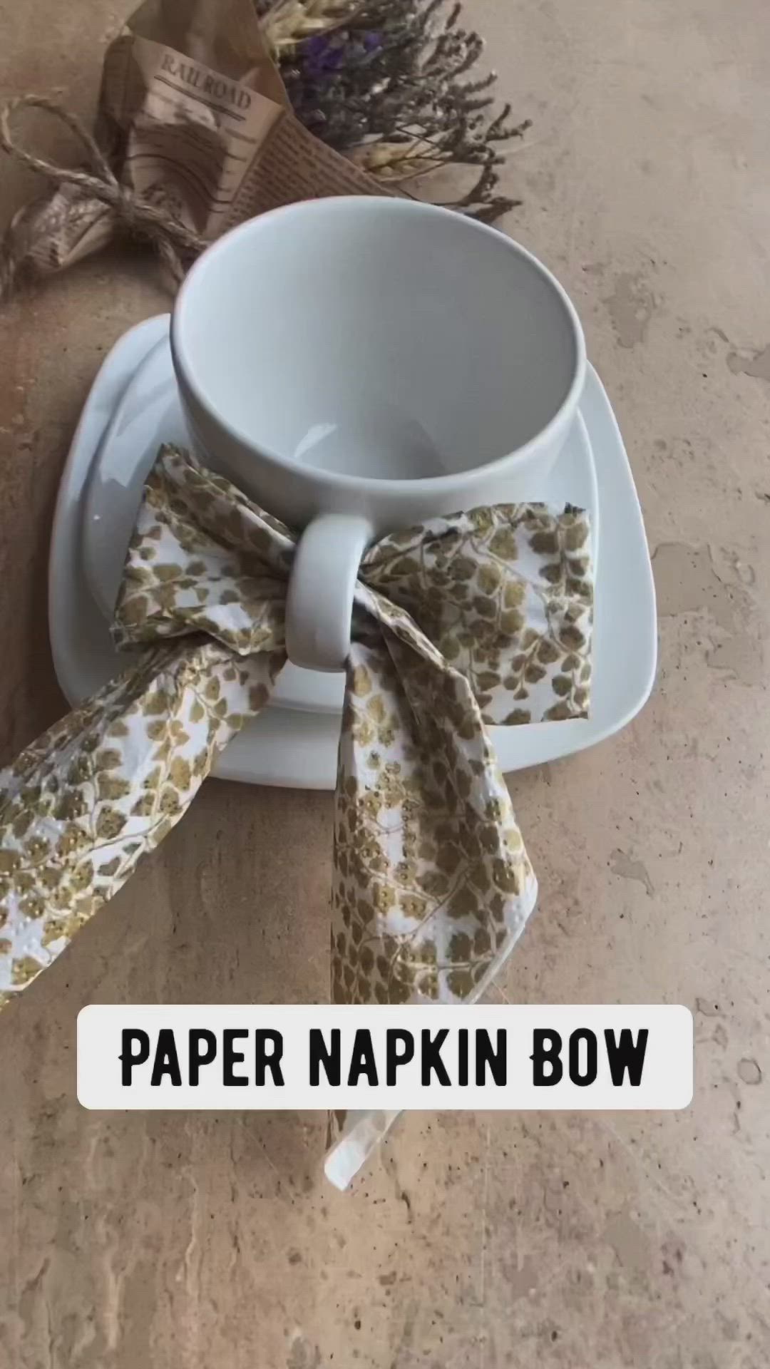 This may contain: a cup and saucer with a bow on it