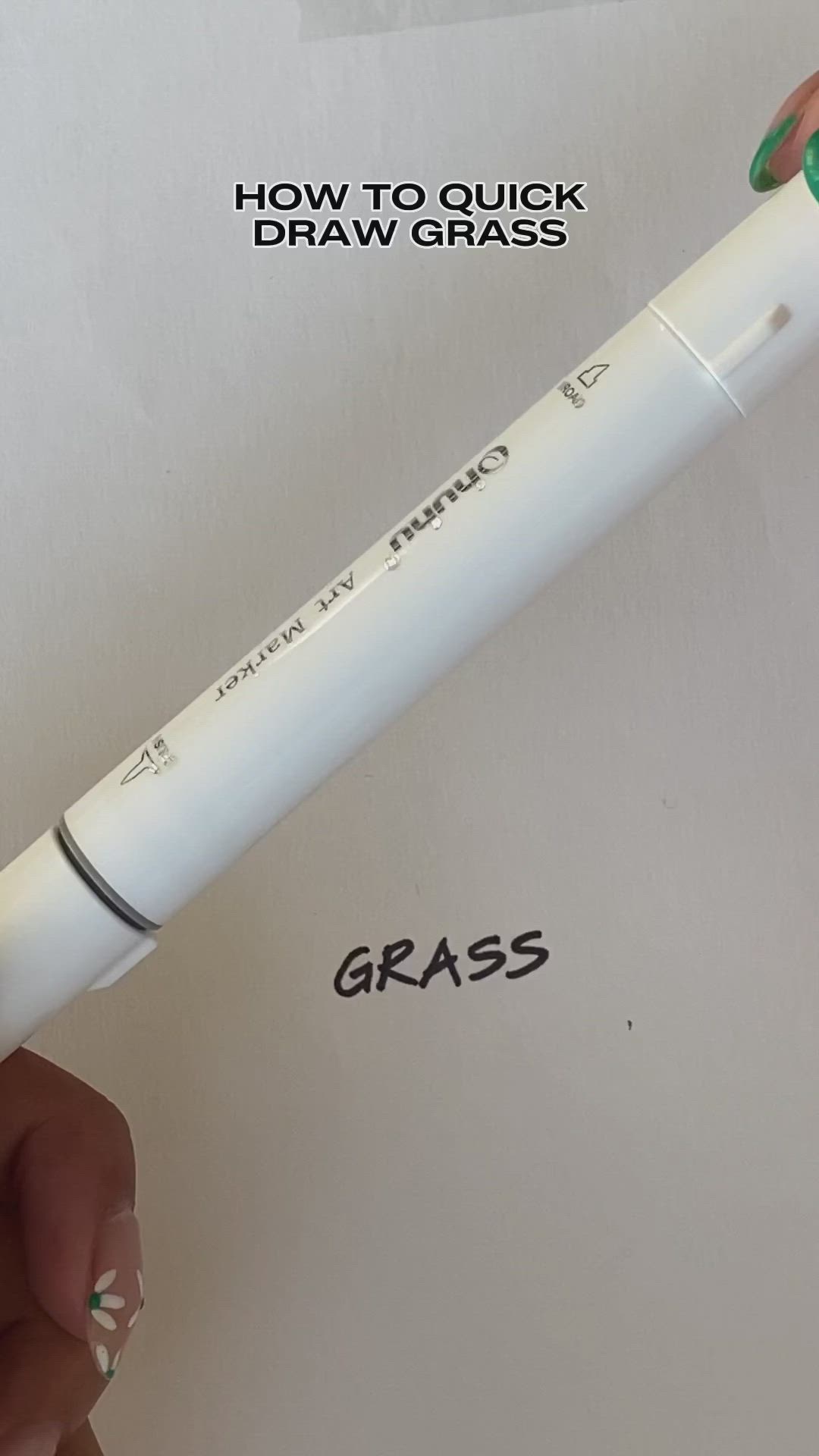 This may contain: someone is drawing grass on paper with marker