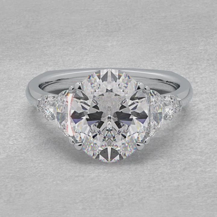 This may contain: an oval cut diamond ring with three pear shaped diamonds