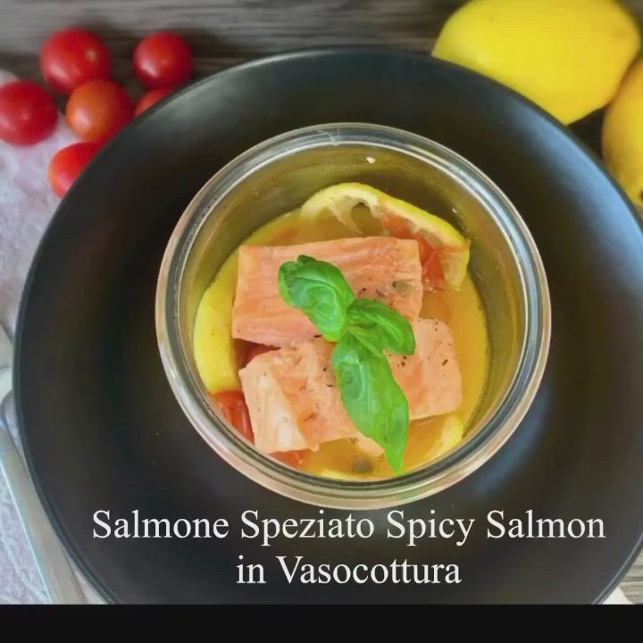 This may contain: salmon in sauce with tomatoes and lemons on the side