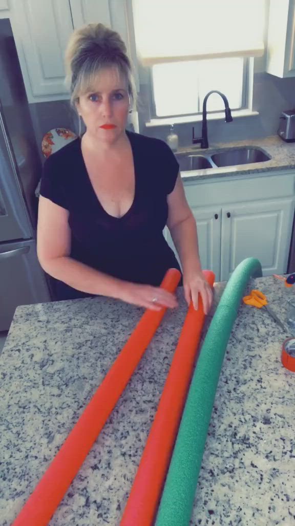 This may contain: a woman is making some carrots out of plastic tubes on the kitchen counter top