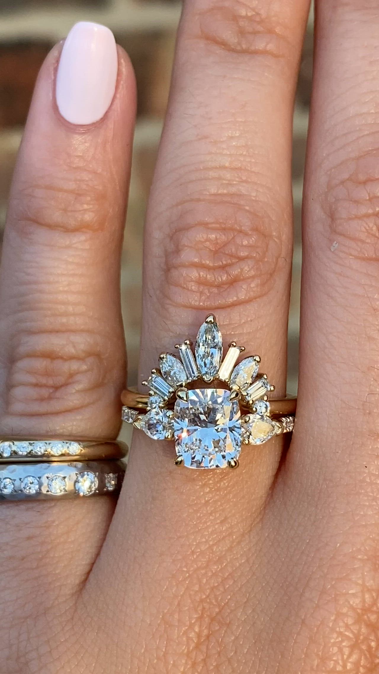 This may contain: a close up of a person's hand with two rings on their fingers and one ring