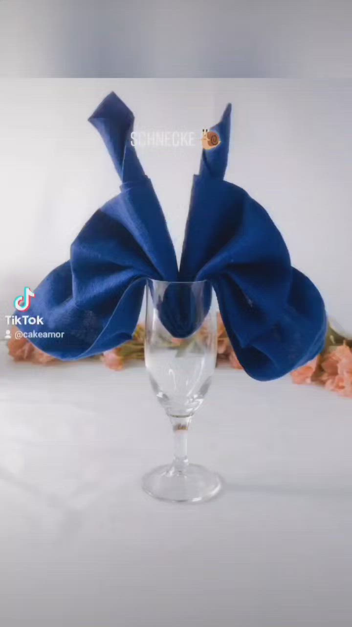 This may contain: a wine glass with a blue bow on it