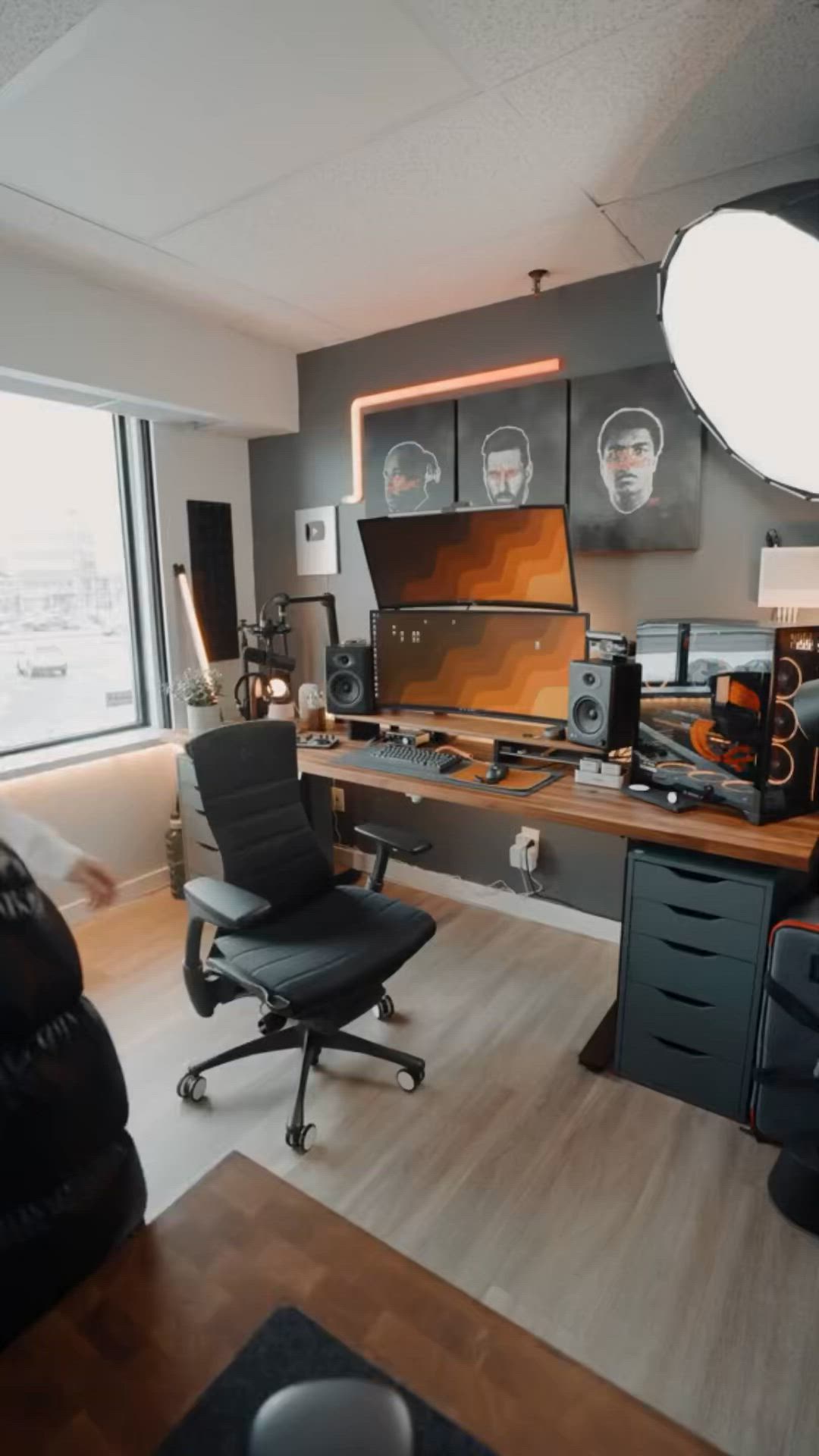 This may contain: a room that has some chairs and desks in it, with lights on the wall