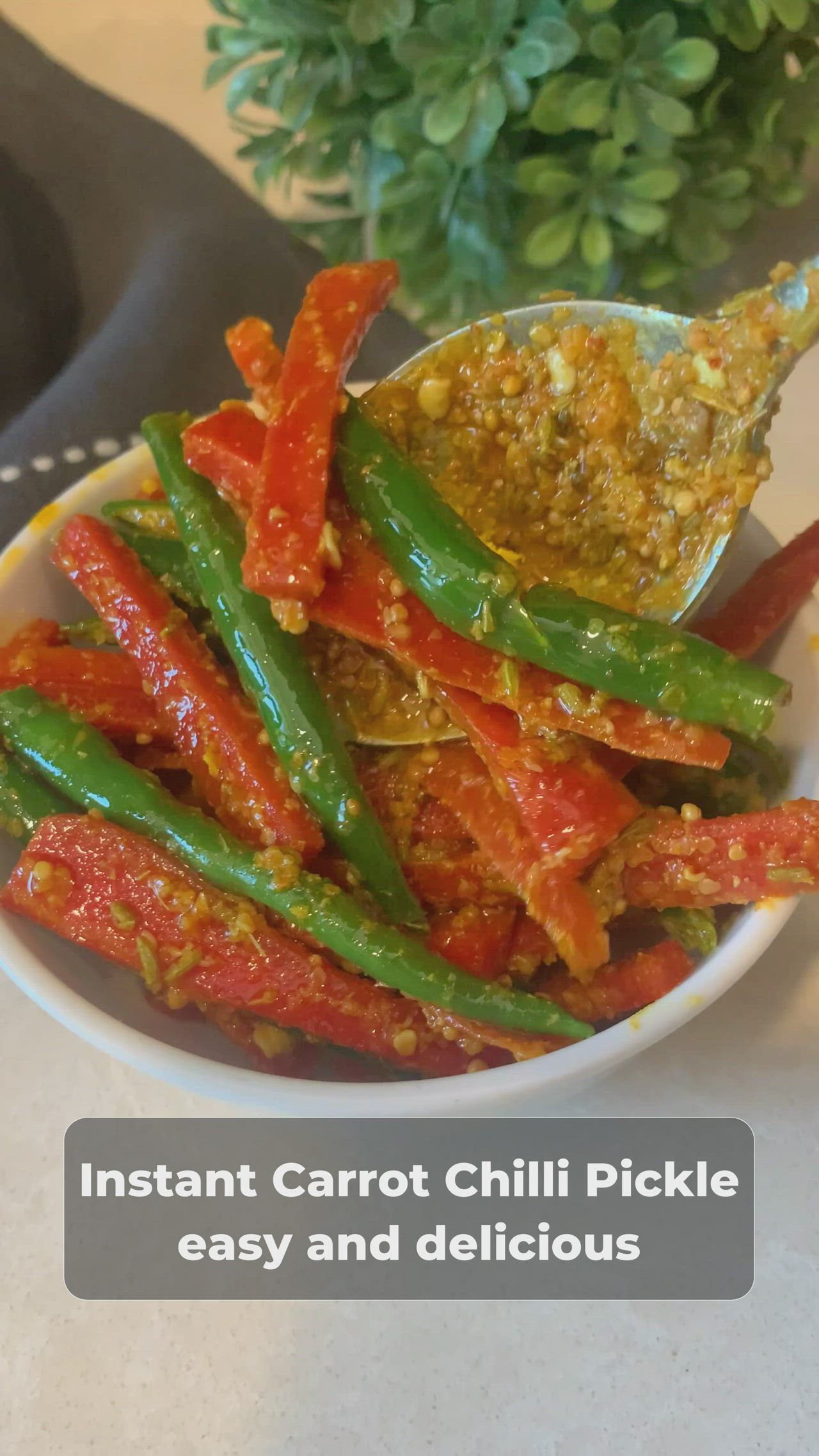 This may contain: a white bowl filled with green beans and red peppers next to a potted plant