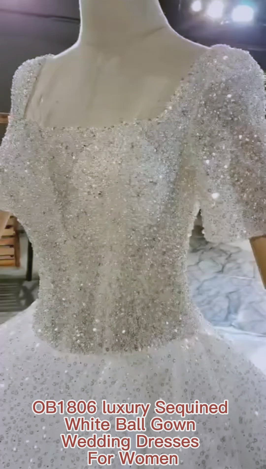 This may contain: a white ball gown with sequins and beading on the boudon