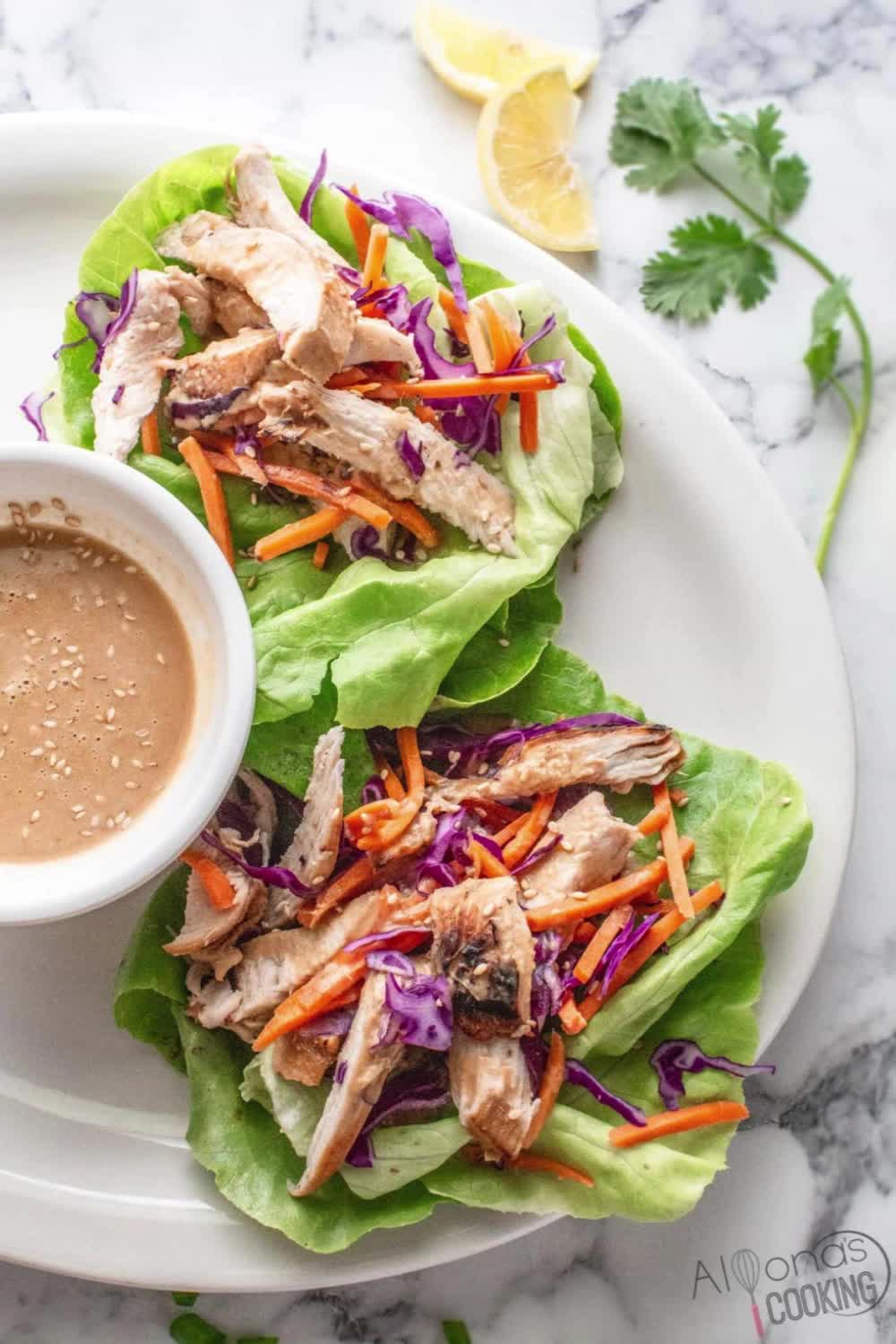 This contains: Looking for a healthy lunch option or Paleo recipe for a healthy option? Chicken breast strips are layered over Boston Lettuce leaves with carrots, purple cabbage, and a quick peanut butter dressing! Serve as a dinner salad or wrap around Boston lettuce leaves! These chicken lettuce leaves are so good you can’t tell it is diet food (paleo, whole30, gluten-free, and dairy-free!)

#chickenrecipe #chickenwrap #lettucewrap #healthylunch #lunchidea