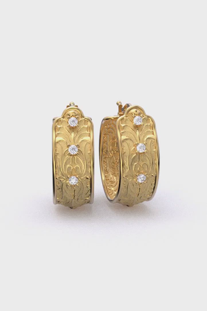 This contains: baroque hoop earrings made in Italy in 14k or 18k solid gold. These exquisite Italian Baroque diamond hoop earrings are made of 14k or 18k gold and feature a 22mm diameter. They are designed and crafted in Italy by Oltremare Gioielli.