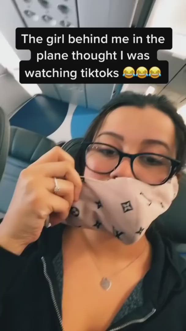 This may contain: a woman wearing glasses and a face mask with the caption'the girl behind me in the plane thought i was watching tiks