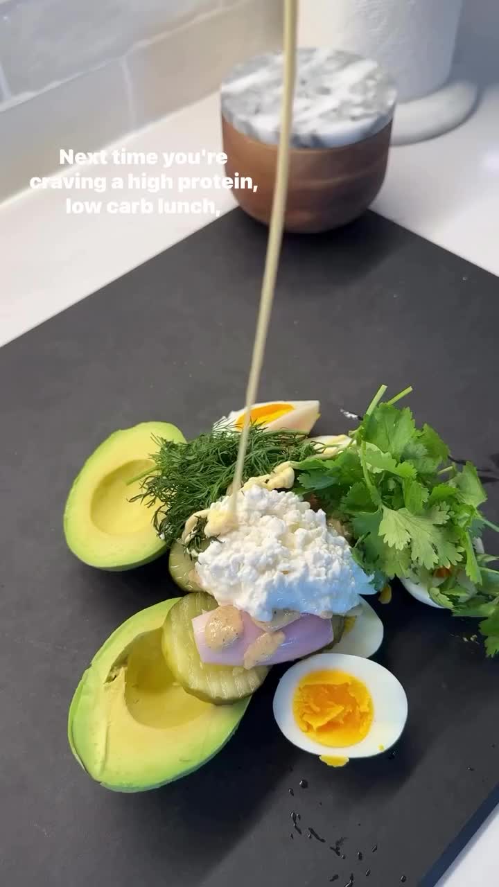 This may contain: an avocado is cut in half on a cutting board next to some other food