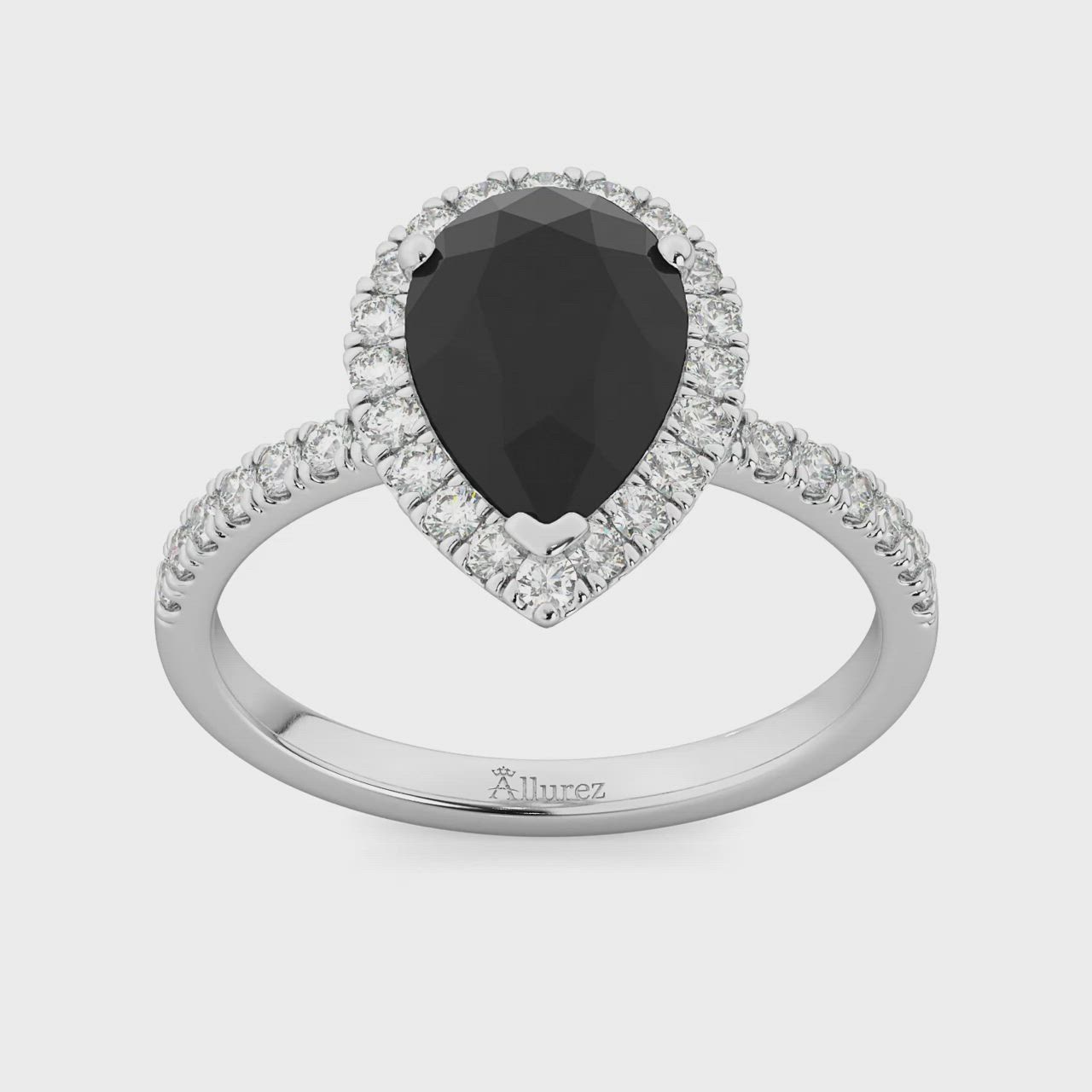 This may contain: a pear shaped black diamond ring with white diamonds on the band and an oval center stone