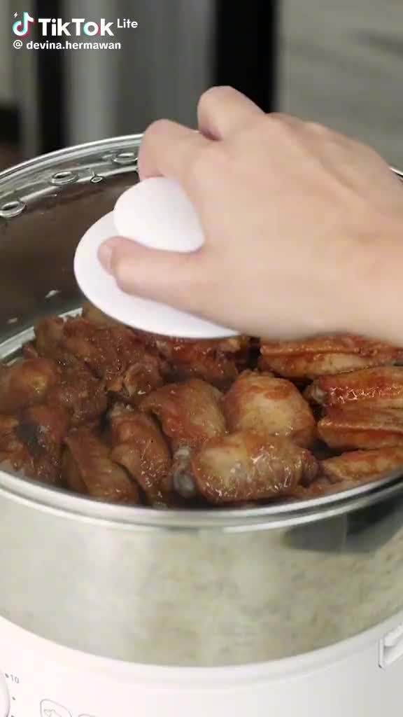 This may contain: a person using a spatula to stir food in a pot