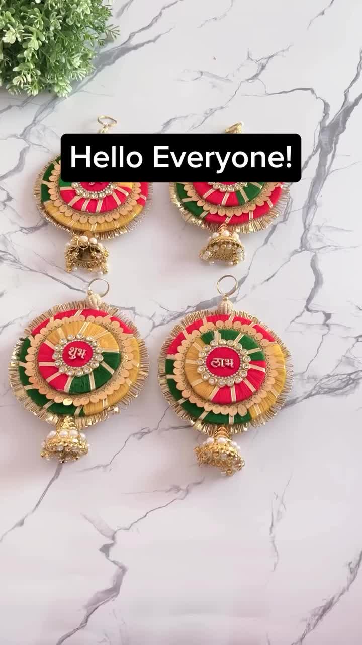 This may contain: three earrings with the words hello everyone on them