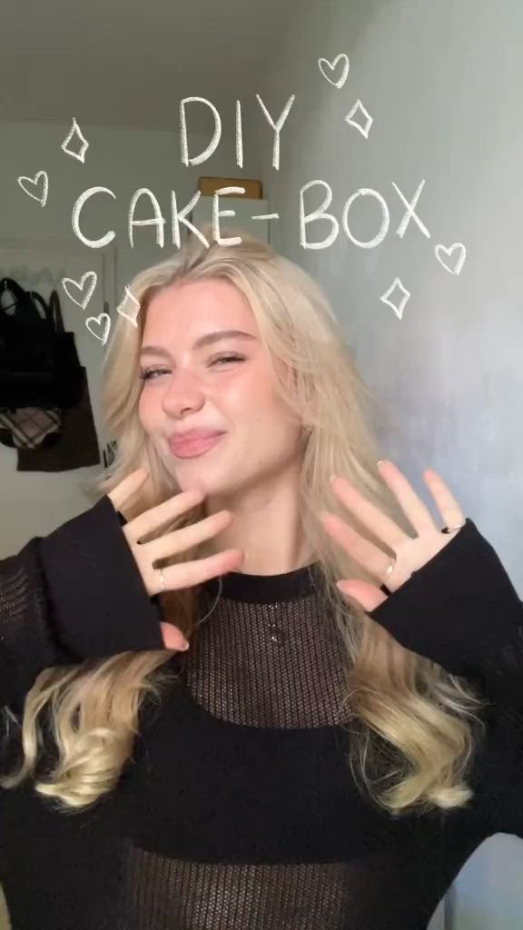 This may contain: a blonde woman with her hands in front of her face and the words diy cake box above her