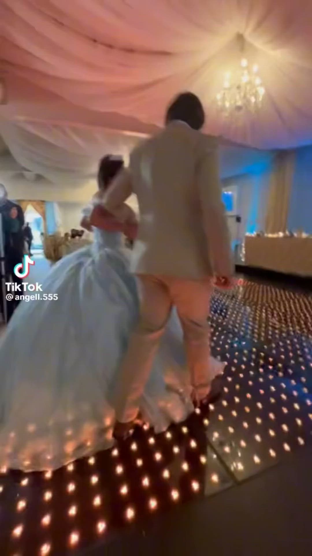 This may contain: a bride and groom are dancing on the dance floor