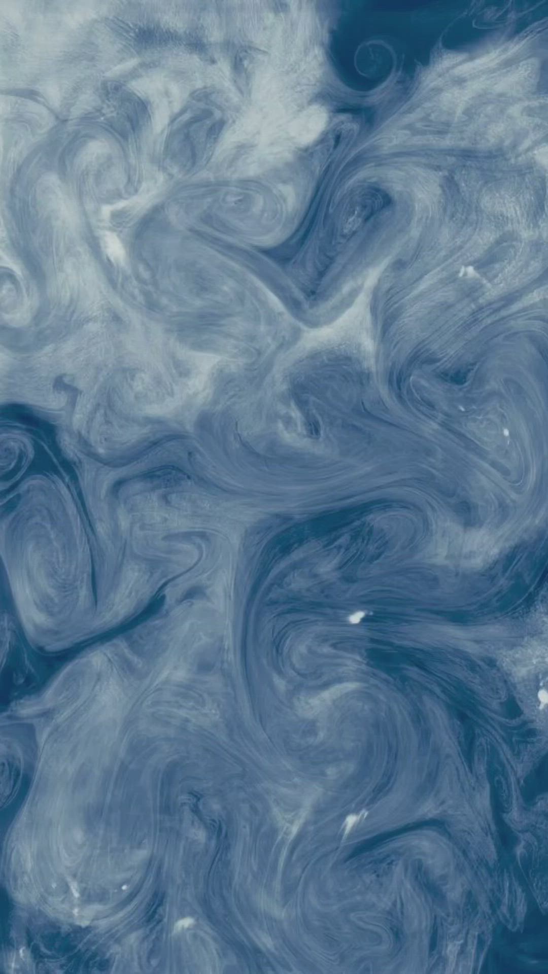 This may contain: blue and white swirls in the water