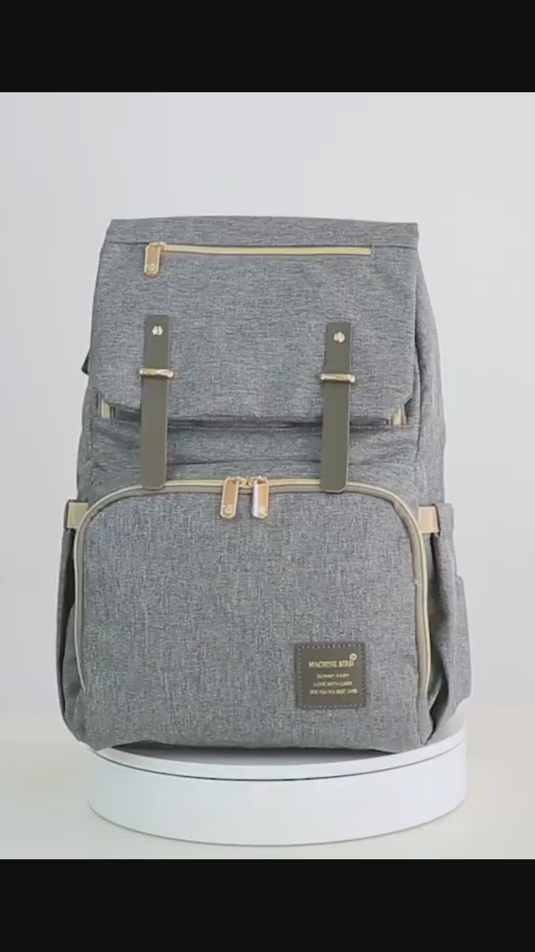 This may contain: a gray backpack sitting on top of a white table