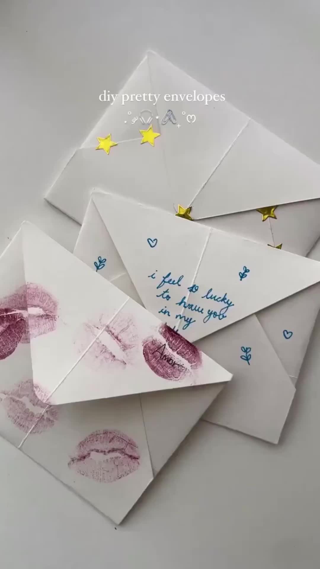 This may contain: four envelopes with handprinted lips and stars on them, one has a note attached to it