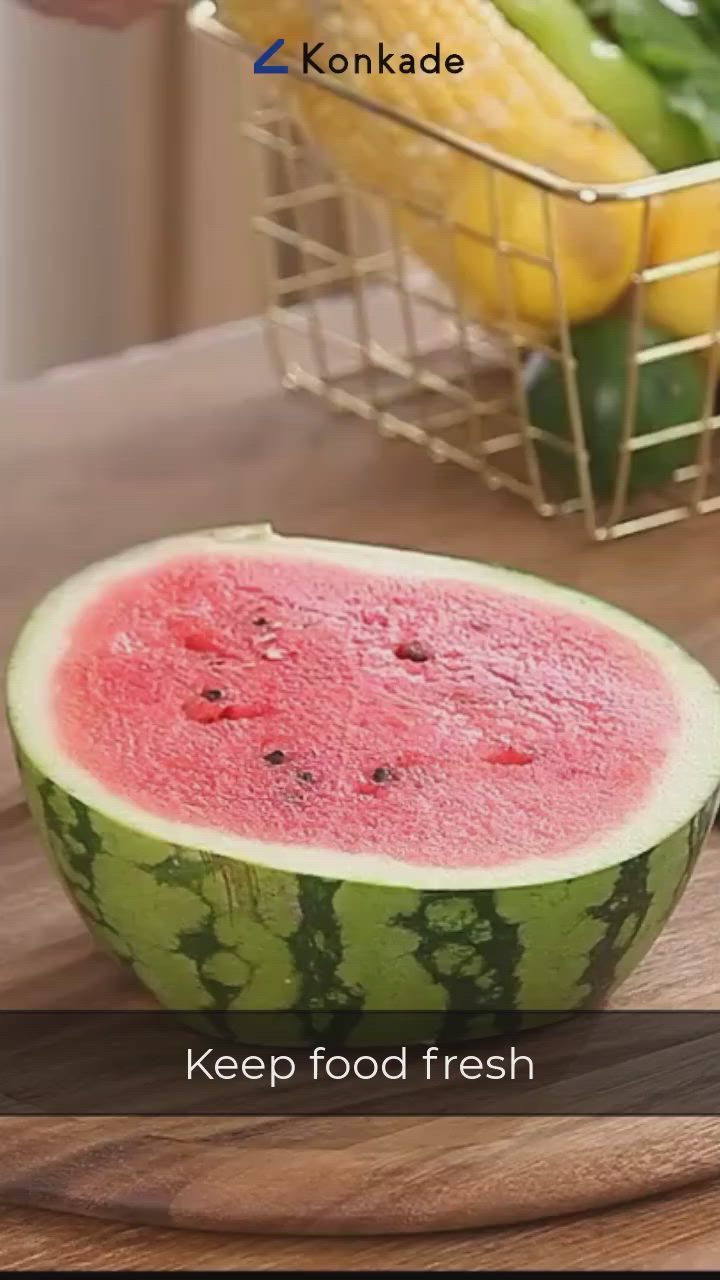 This may contain: a watermelon is cut in half on a cutting board with the words keep food fresh