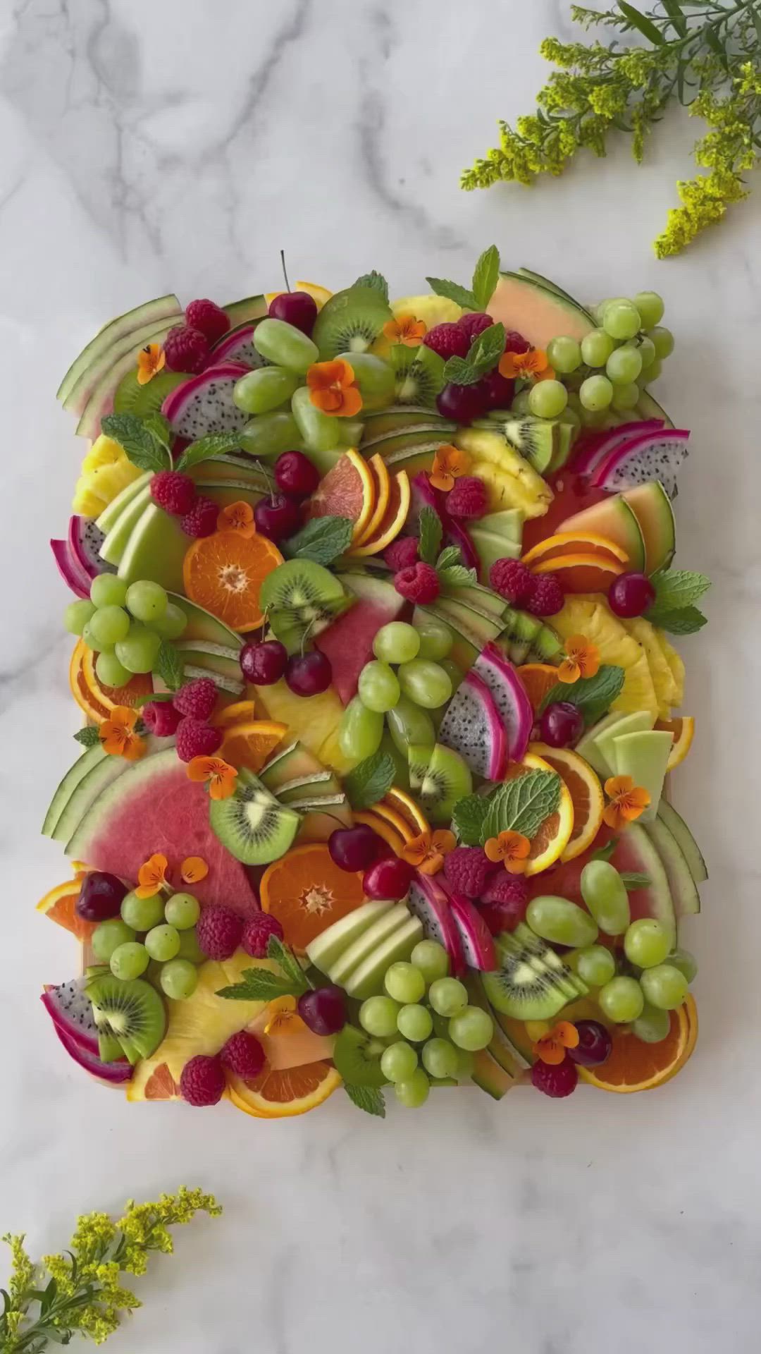 This may contain: a platter filled with lots of different types of fruits and vegtables