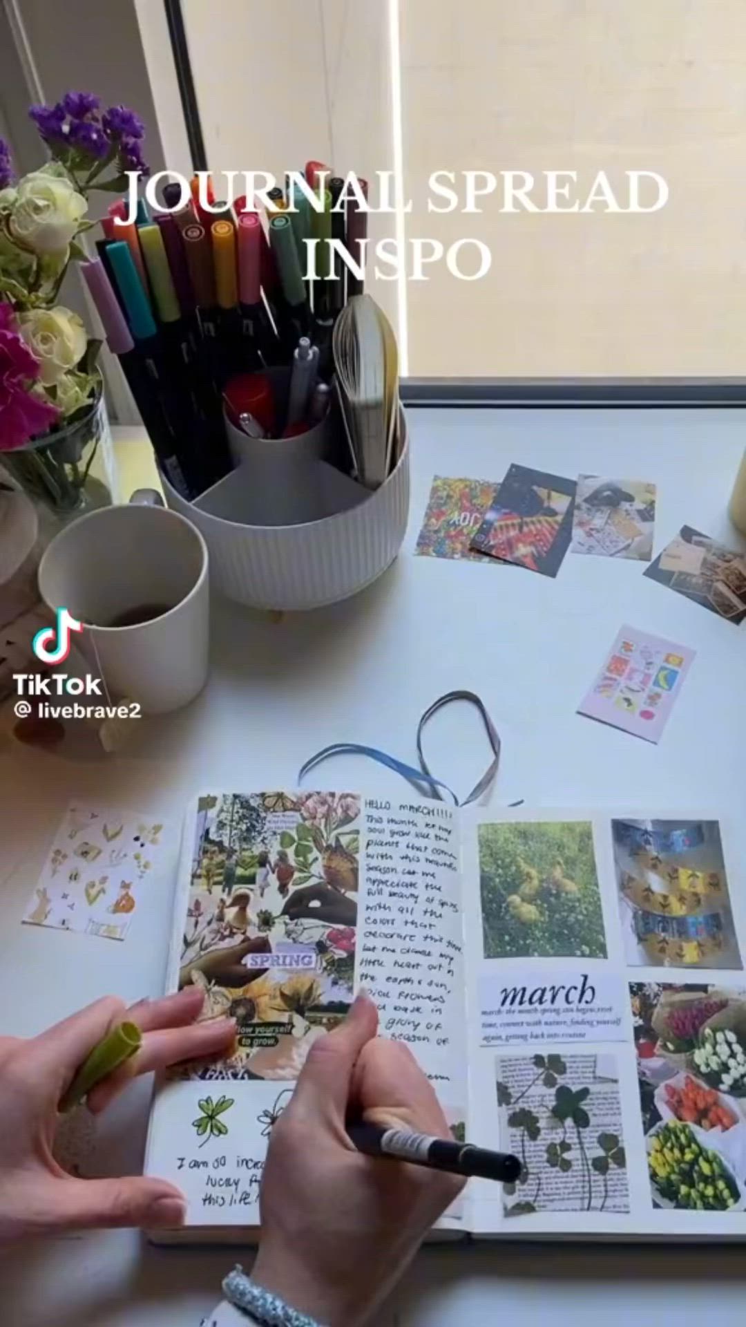 This may contain: a person is writing on a book with flowers in the background