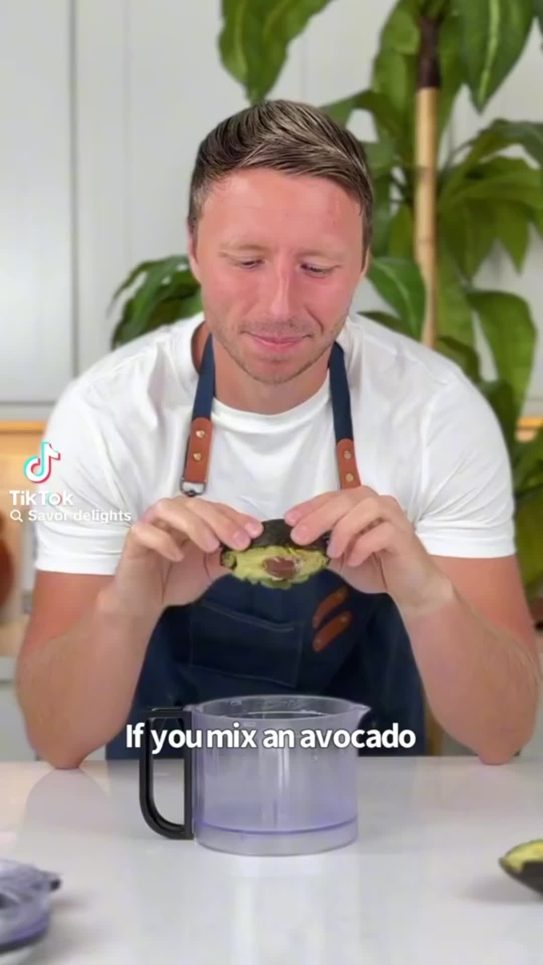 This may contain: a man sitting at a table with a blender in front of him and the words if you mix an avocado