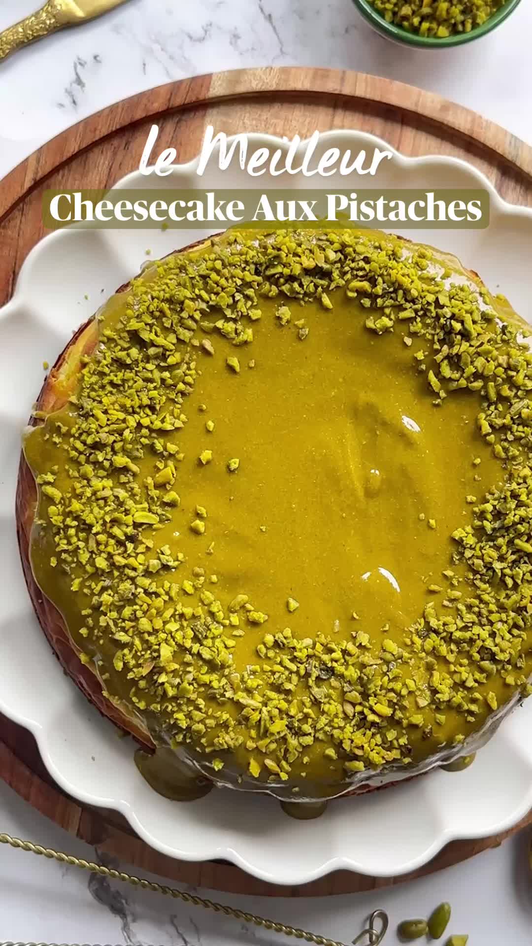 This may contain: a slice of cheesecake with pistachios on a plate