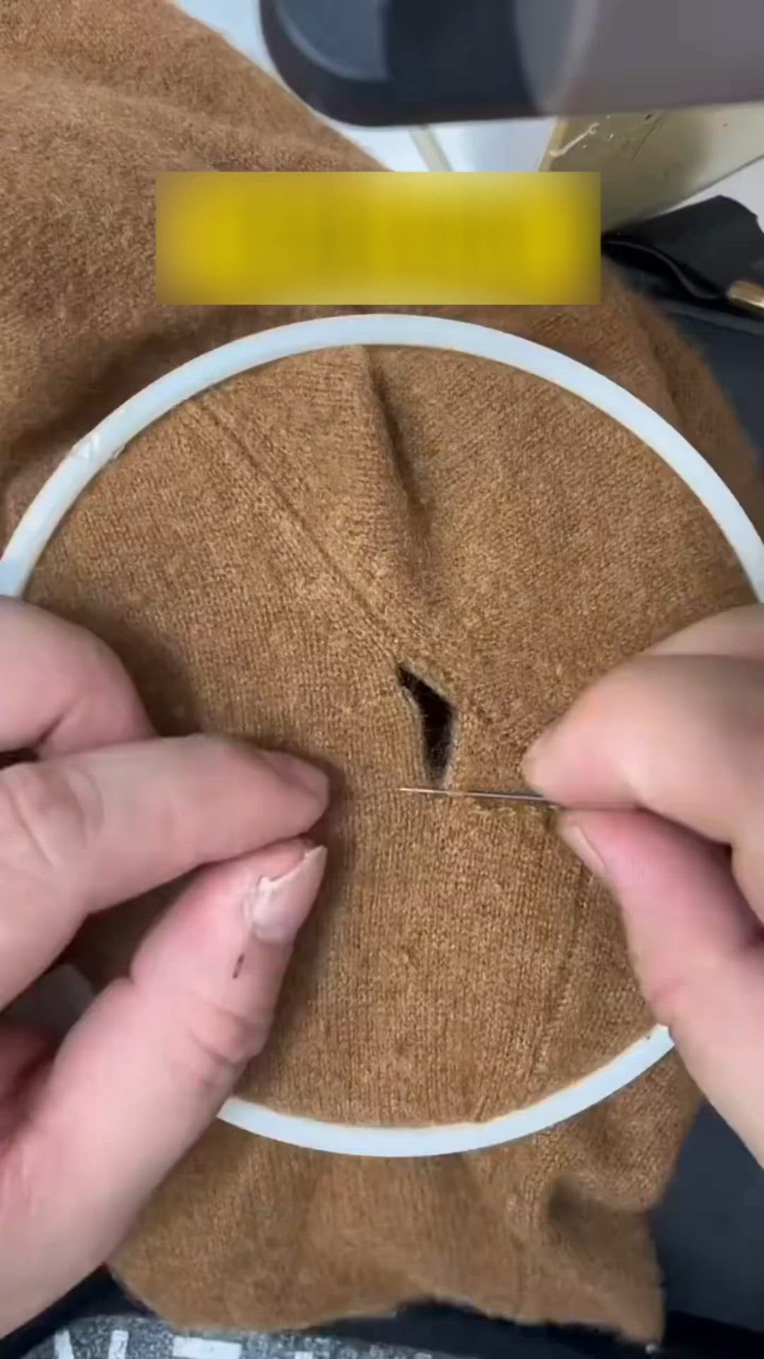 This may contain: two hands are working on a piece of fabric that has been stitched together with scissors