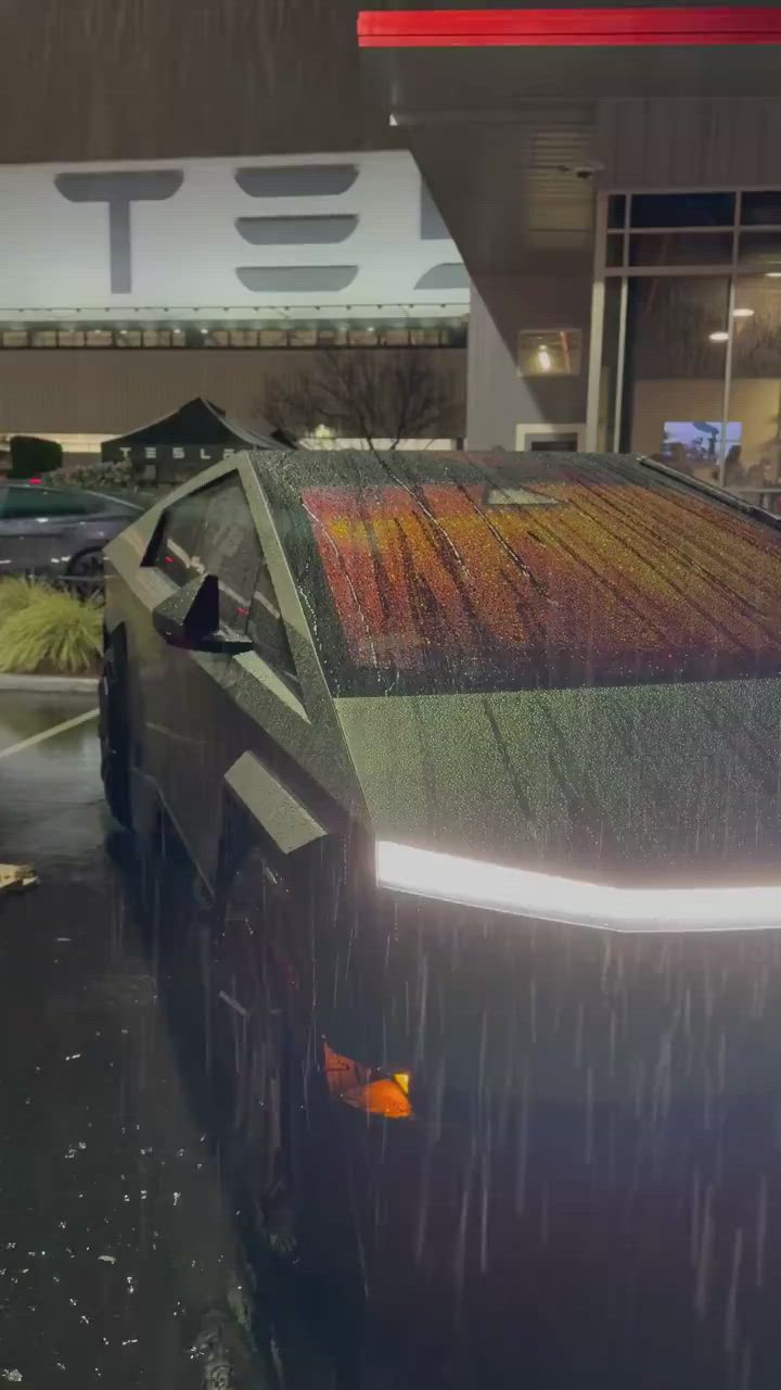 This may contain: a car that is sitting in the rain