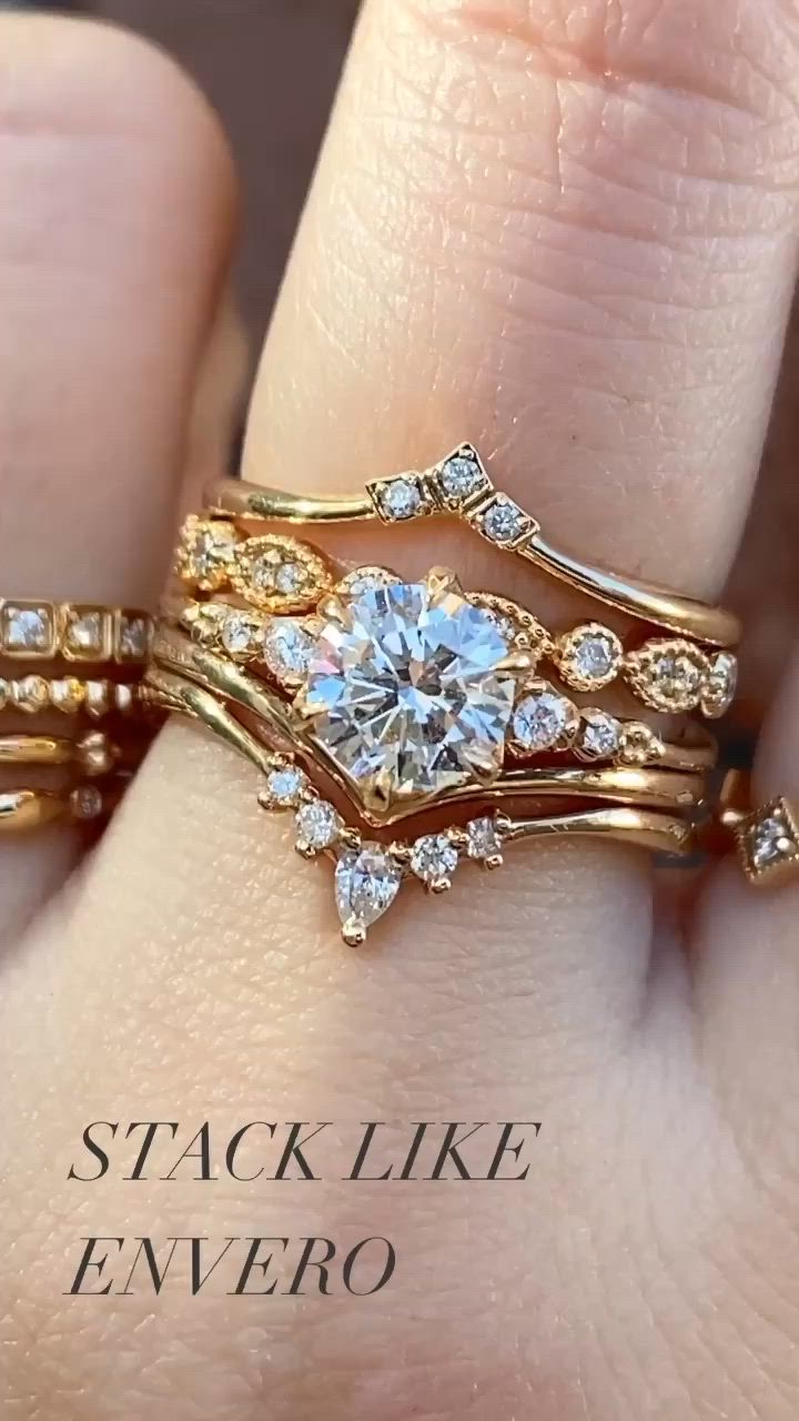 This may contain: a close up of a person's hand with two wedding rings on their fingers