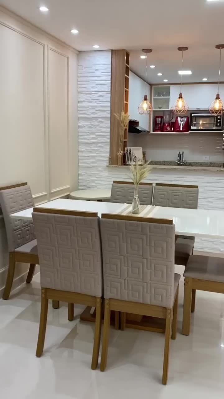 This may contain: a dining room table and chairs with white tile flooring