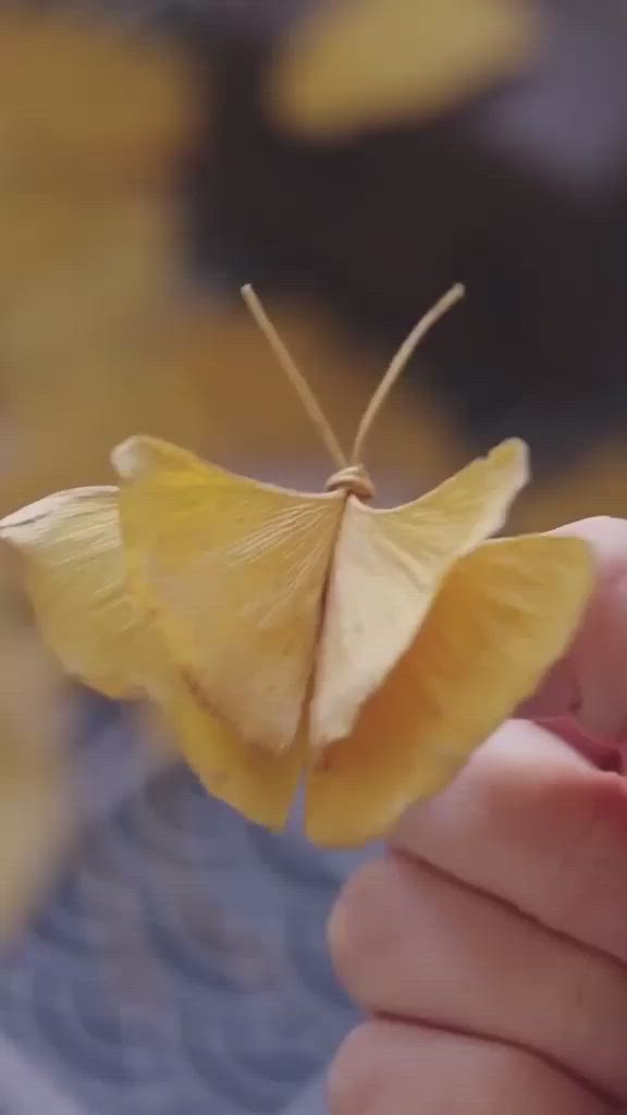 This may contain: a small yellow butterfly sitting on top of someone's hand