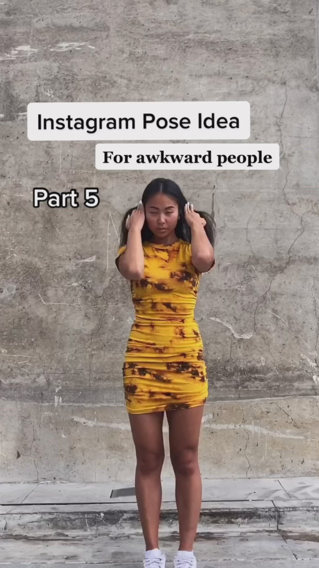 This may contain: a woman standing in front of a wall with her hands on her head and the words instagram pose idea for awkward people part 5