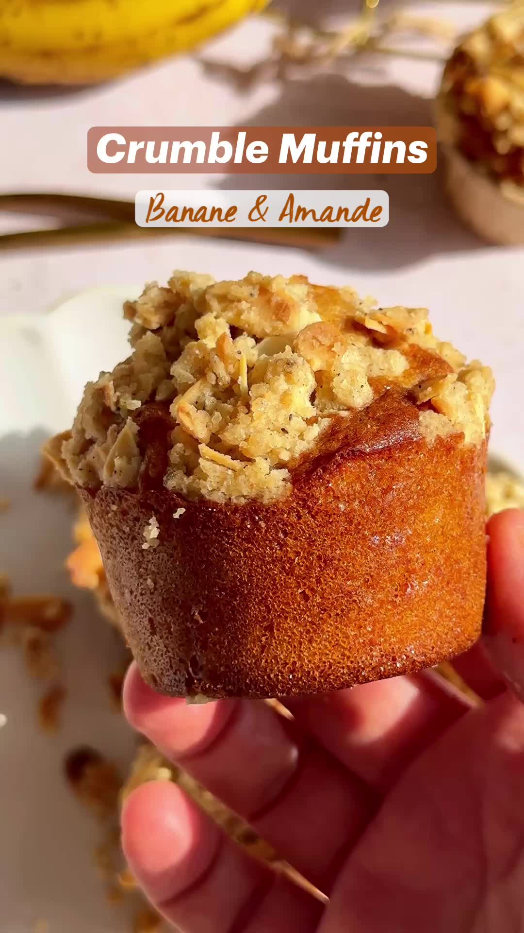 This may contain: crumble muffins on a plate with bananas in the background