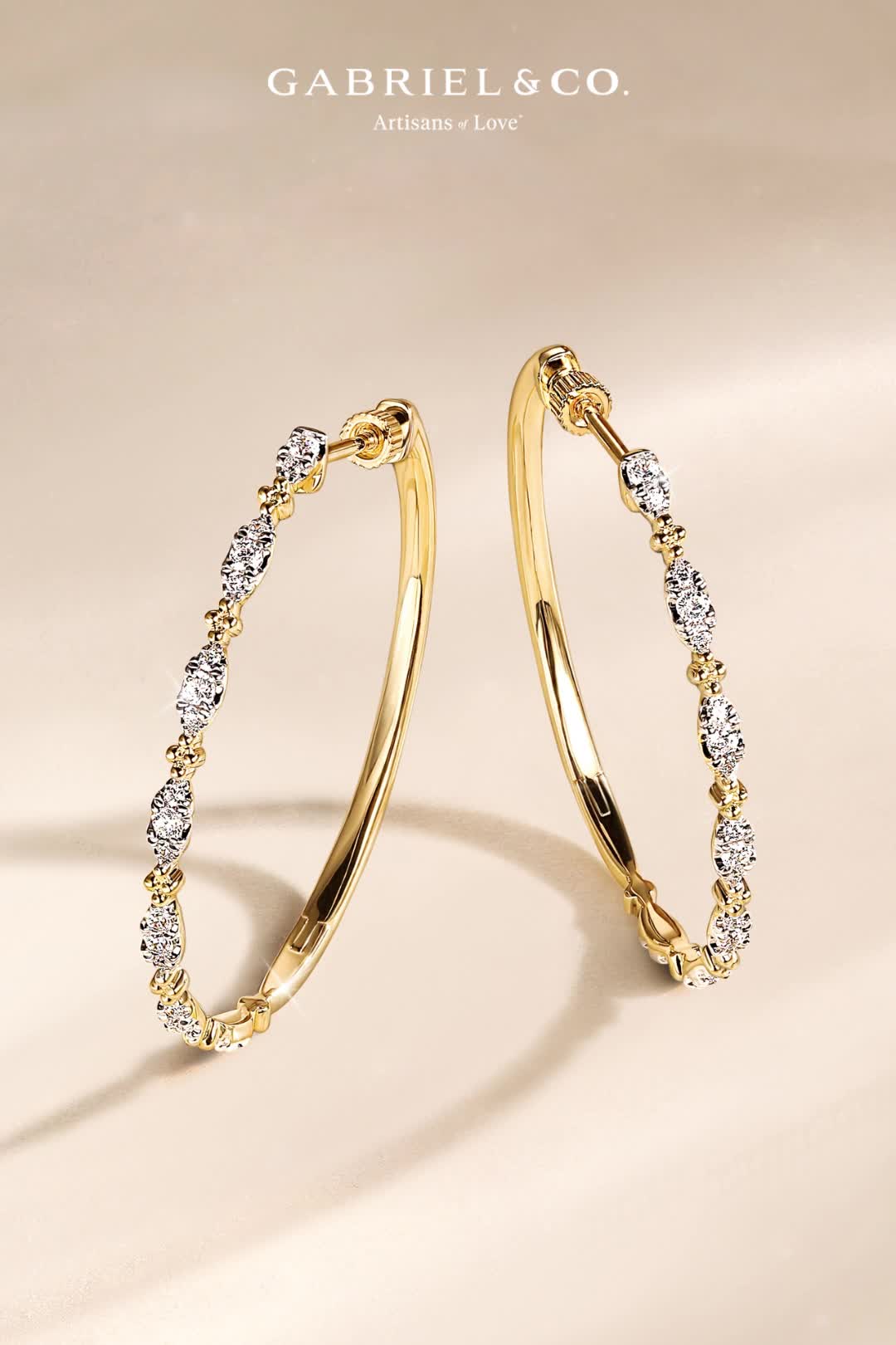 These intricate 40mm hoop earrings have a distinct style all their own. Fashioned in 14K yellow gold, the front of each hoop boasts an alternating pattern of shining gold beads and radiant marquise shaped diamond clusters. Screwback closures secure these 0.55ct diamond station hoops.