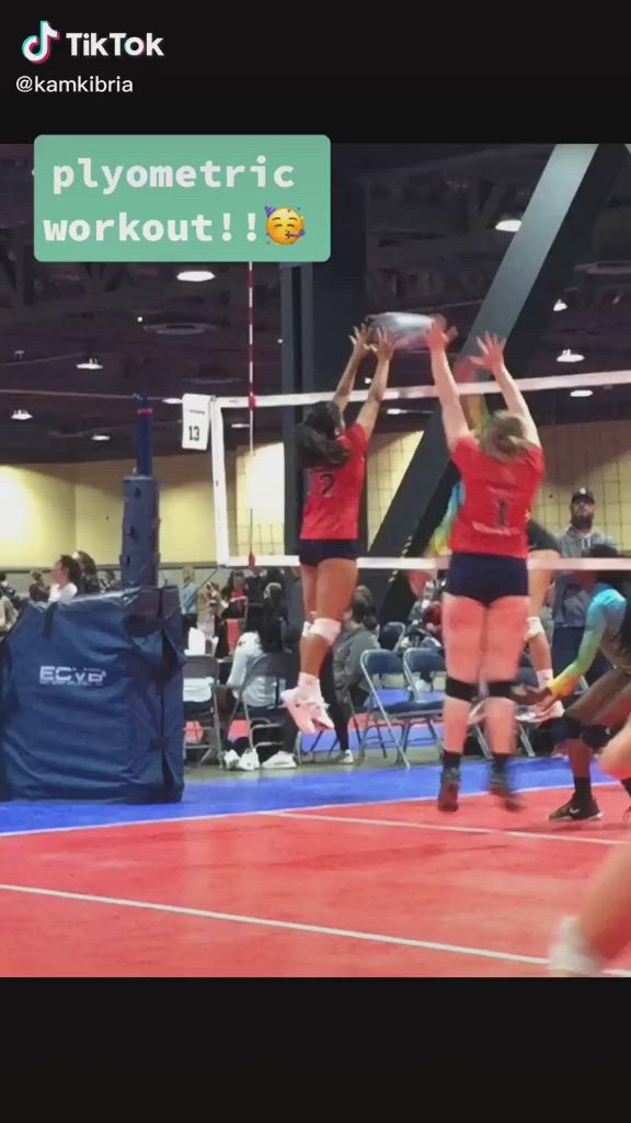 This may contain: some girls are playing volleyball on a court