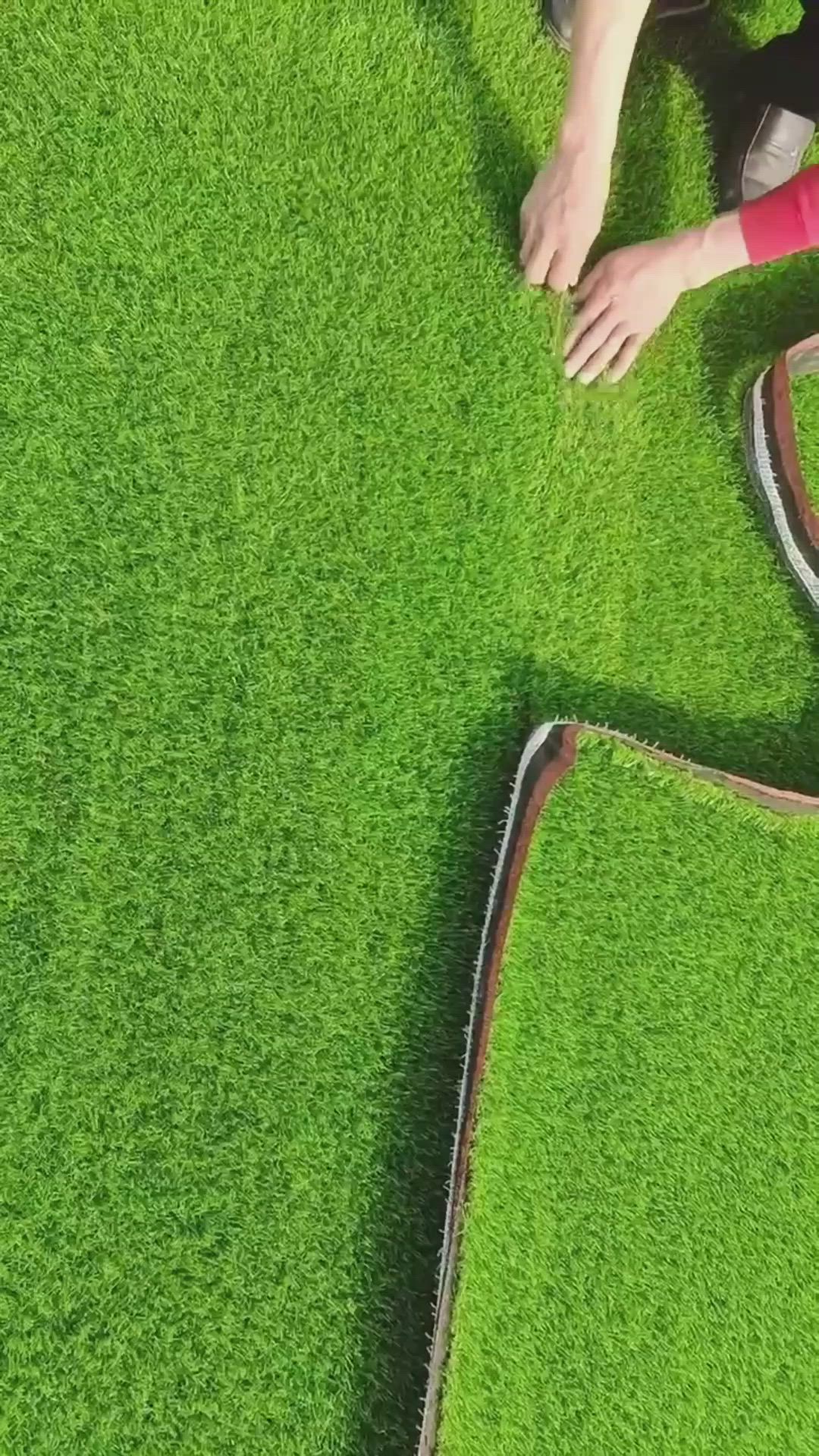 This may contain: a man laying on top of a lush green field