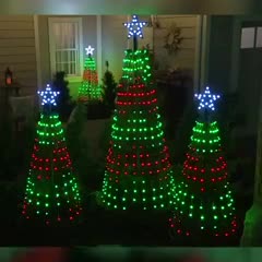 This may contain: lighted christmas trees in front of a house